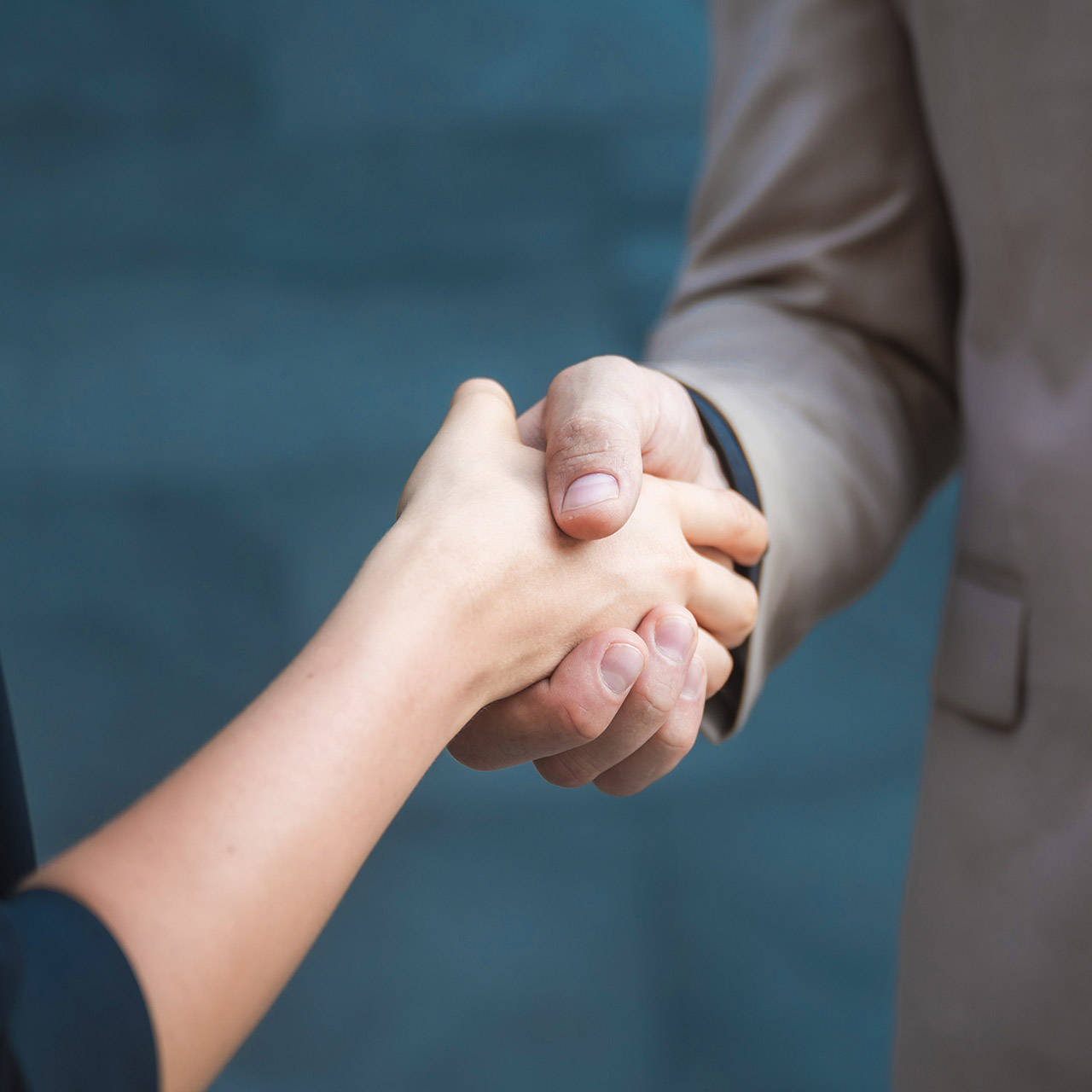 Two confident business man shaking hands during a meeting in the office, partner with business success concept.